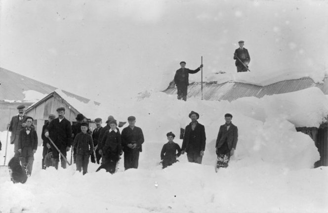 Group in snow at St Bathans, Central Otago - Photograph taken by F M Pyle. Paterson, M, fl 1966 : Photographs, particularly of St Bathans, Central Otago. Ref: 1/2-027135-F. Alexander Turnbull Library, Wellington, New Zealand. http://natlib.govt.nz/records/22349697