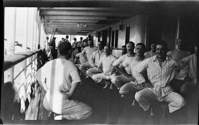 Officers exercising on a transport ship. Negatives taken by Rev Ernest Northcroft Merrington, all relating to World War 1, chiefly Gallipoli. Ref: 1/2-077943-F. Alexander Turnbull Library, Wellington, New Zealand. http://natlib.govt.nz/records/22634165