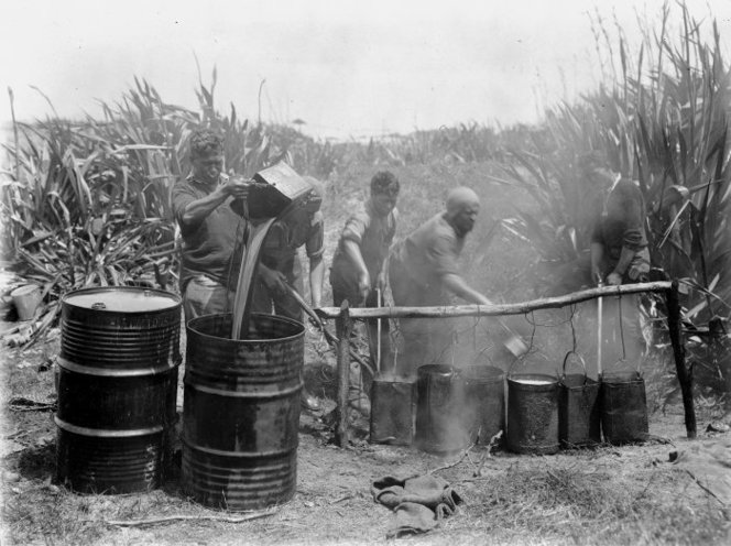 Men boiling down blackfish blubber, Tokerau Beach. Taaffe, James Thomas Benjamin, d 1971 :Photographs of the Far North district, Northland region. Ref: 1/2-026801-F. Alexander Turnbull Library, Wellington, New Zealand. http://natlib.govt.nz/records/23070974