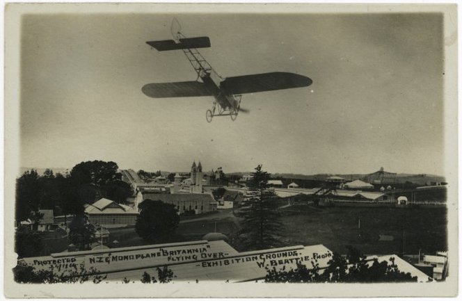 Beattie, William, 1864-1931. Bleirot monoplane Britannia flying over Auckland Exhibition Grounds. Thompson, D (Mrs) fl 1975 :Postcards of New Zealand scenes. Ref: PAColl-0892-12. Alexander Turnbull Library, Wellington, New Zealand. http://natlib.govt.nz/records/22305336